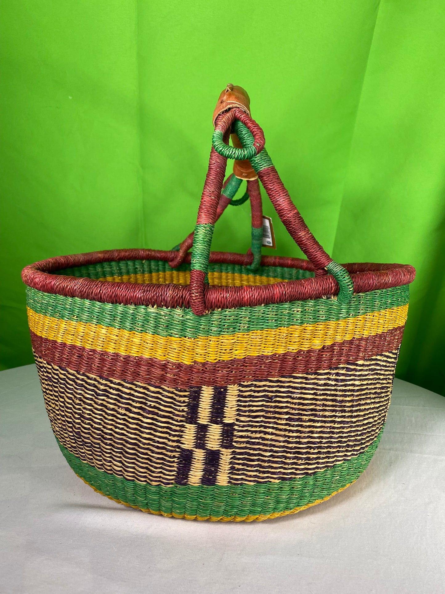 A Beautiful Hand Woven African Basket With A Leather Bound Handle