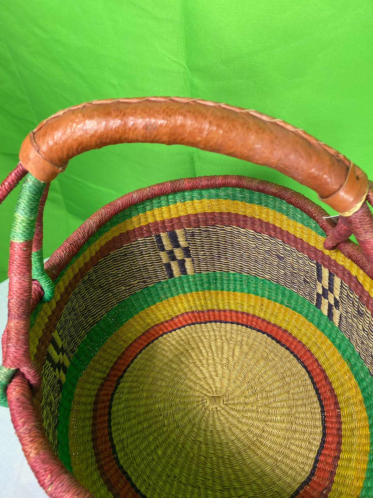 A Beautiful Hand Woven African Basket With A Leather Bound Handle