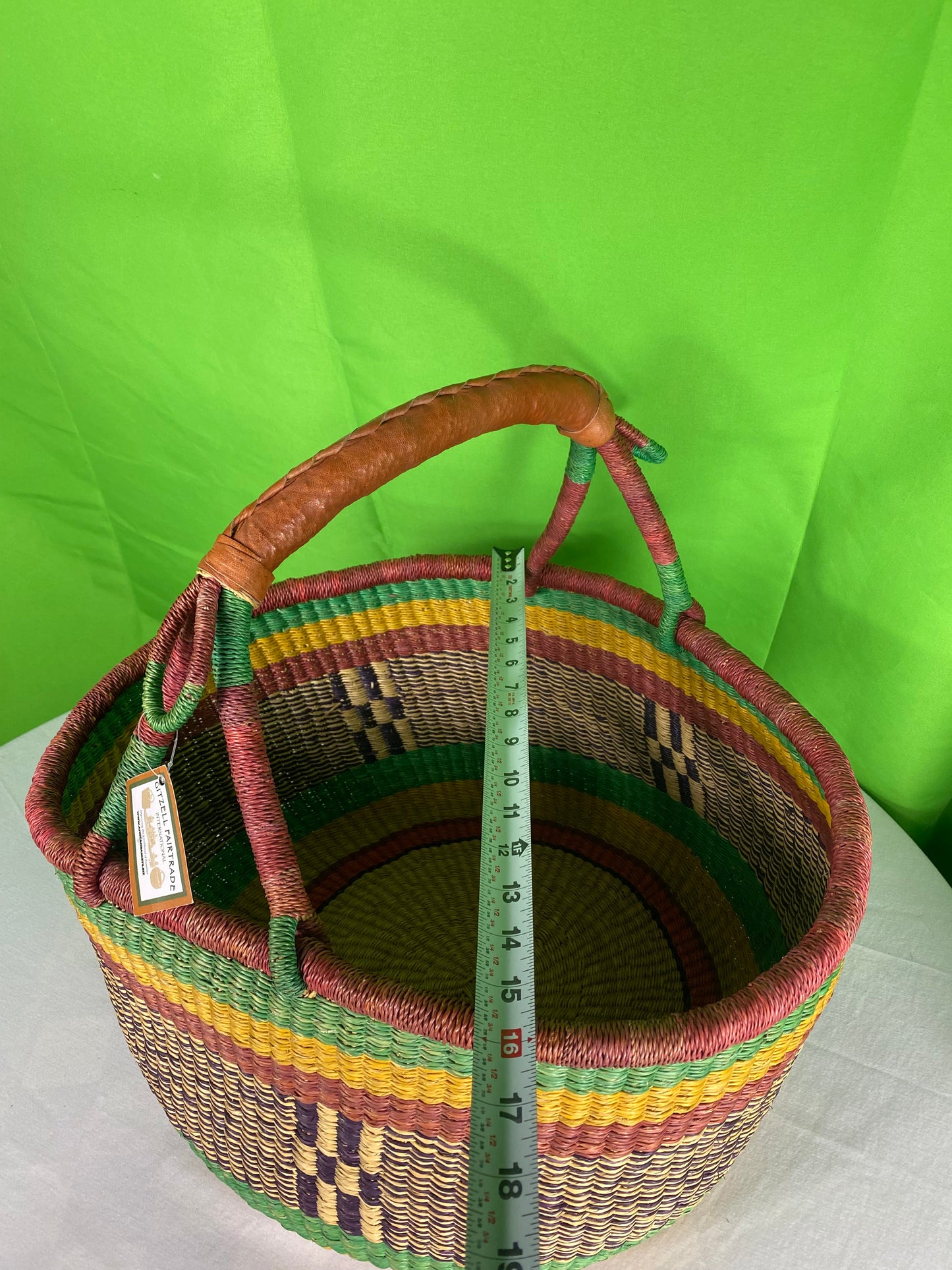 A Beautiful Hand Woven African Basket With A Leather Bound Handle