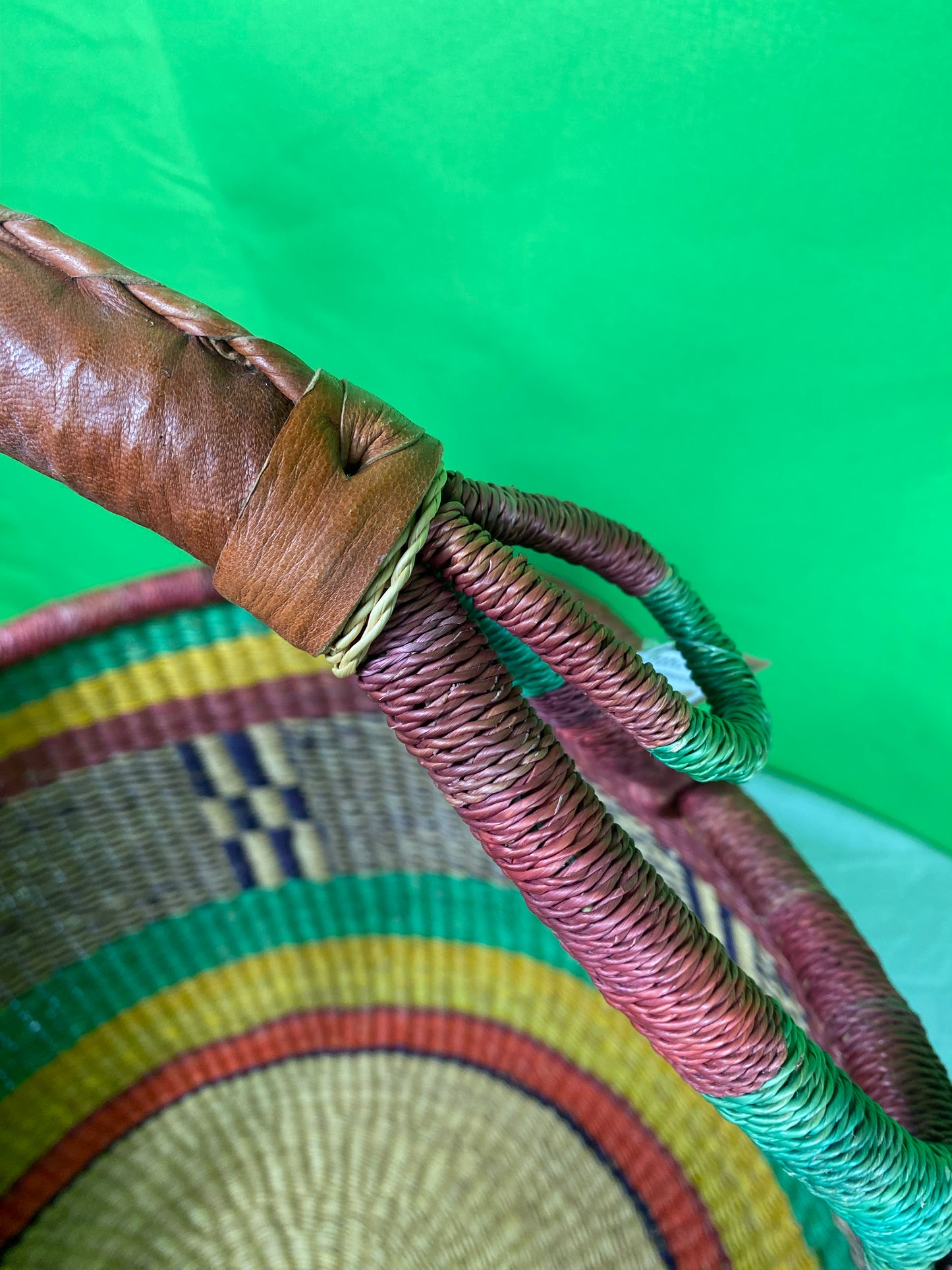 A Beautiful Hand Woven African Basket With A Leather Bound Handle