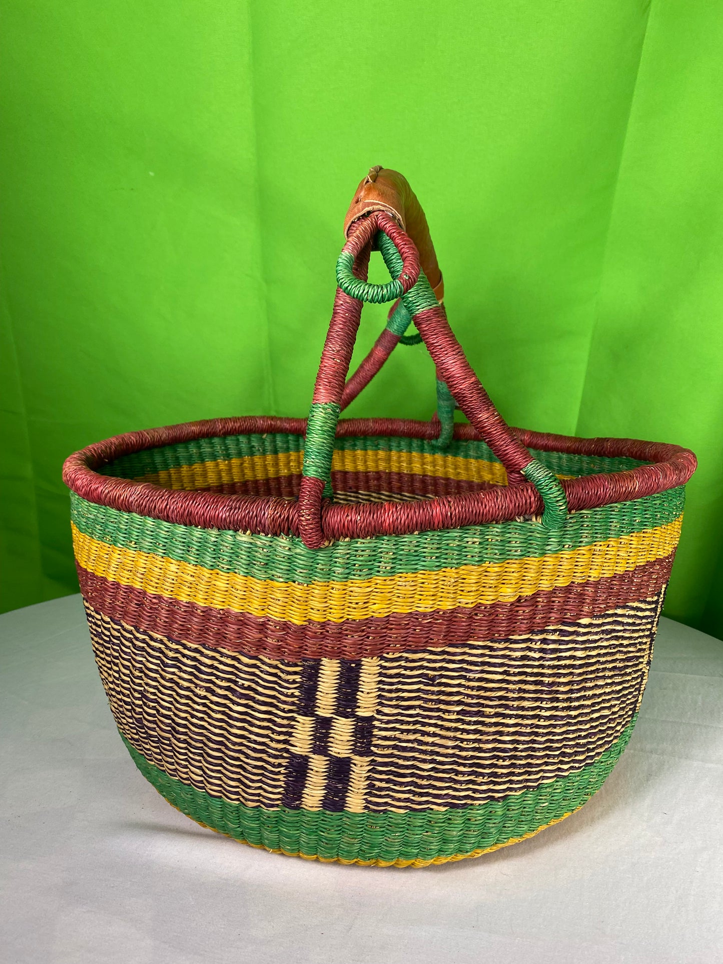 A Beautiful Hand Woven African Basket With A Leather Bound Handle