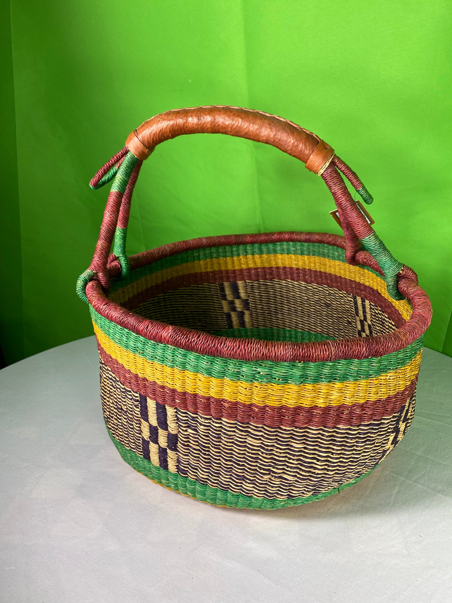 A Beautiful Hand Woven African Basket With A Leather Bound Handle