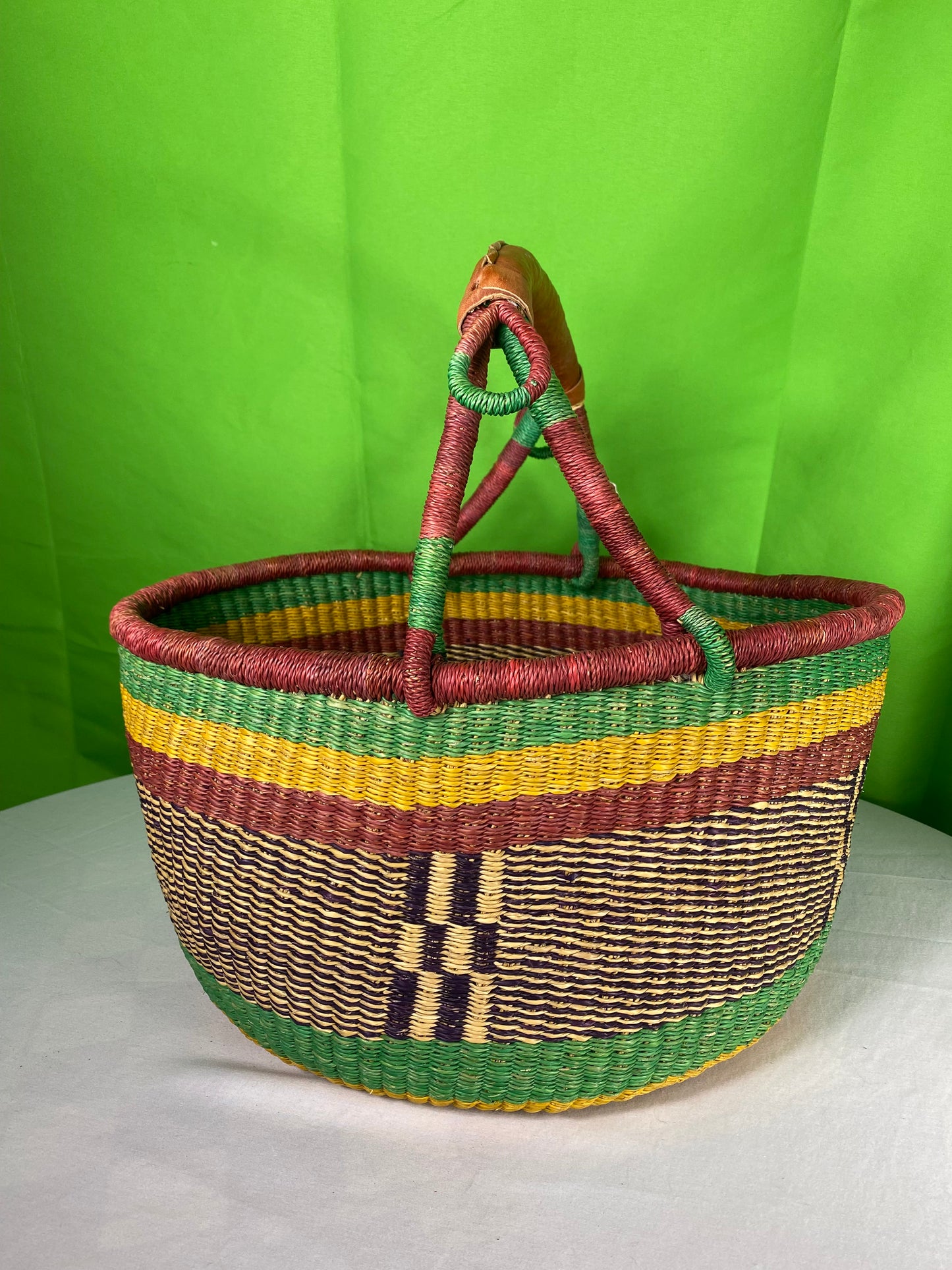 A Beautiful Hand Woven African Basket With A Leather Bound Handle