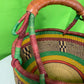 A Beautiful Hand Woven African Basket With A Leather Bound Handle