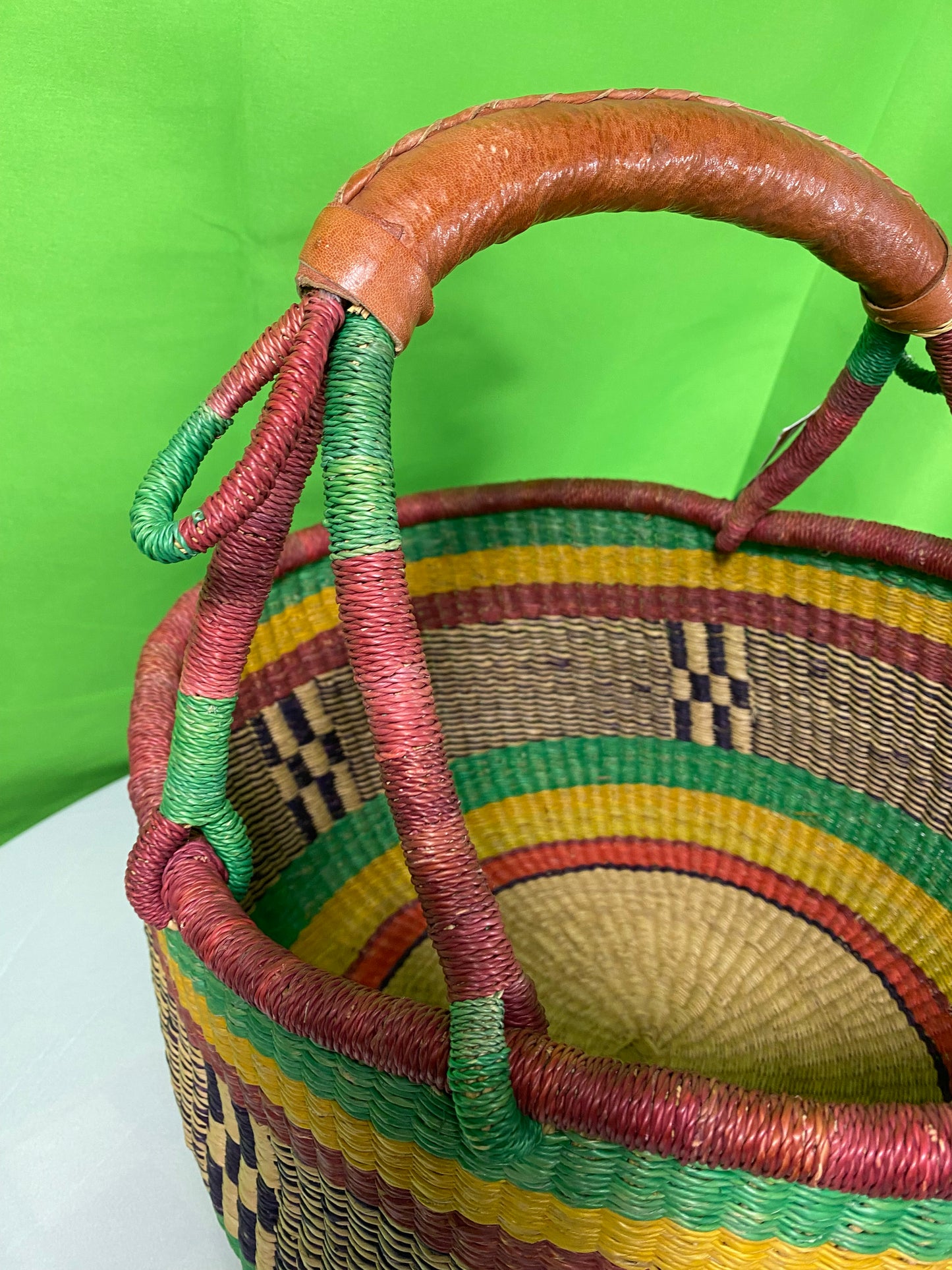 A Beautiful Hand Woven African Basket With A Leather Bound Handle